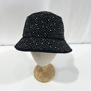 Detailed close-up of sparkling silver rhinestones on a black cotton bucket hat surface