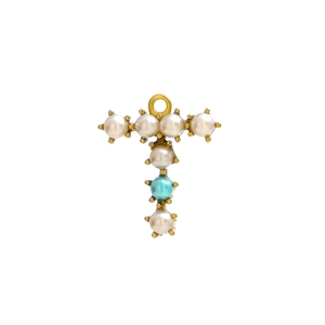 Detailed macro of gold metal T-shaped pendant with white pearl and turquoise inlay