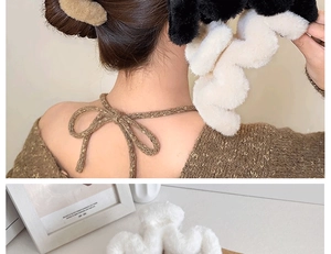 Detailed view of plush wavy hair claws in black, beige, and white colors for thick hair