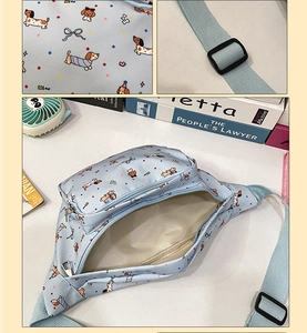 Detail of light blue waist bag showing cartoon dachshund prints and adjustable buckle strap