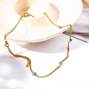 Detail of natural turquoise necklace with tassel zircon pendant on a decorative plate