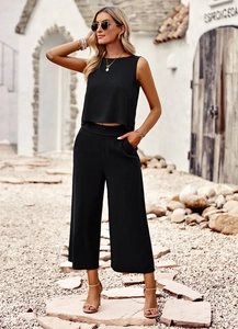 Close-up of black sleeveless top and wide-leg trousers in breathable linen fabric