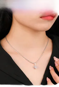 Detailed view of silver heart pendant with pink gemstone on elegant chain