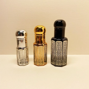 Three elegant crystal perfume bottles with hollow laser coating and metal caps