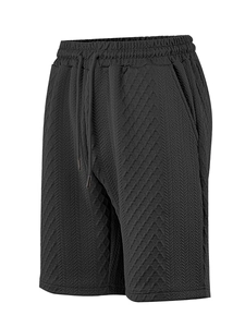 Detailed macro view of black waffle texture fabric and adjustable drawstring on shorts