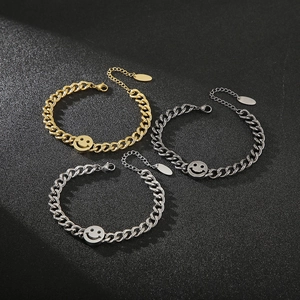 Detail of chunky stainless steel smile face bracelets in gold, silver, and gunmetal finishes
