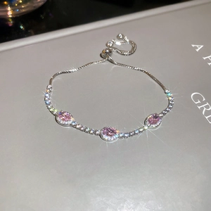 Detail of adjustable silver bracelet featuring three pink oval zircons and micro-pave diamonds