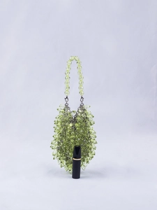 Detail of light green beaded handbag with faceted acrylic crystals and metal clasp