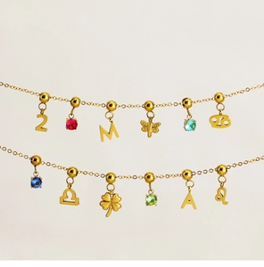 Macro shot of 18K gold plated stainless steel necklaces with zodiac and butterfly charms