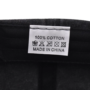 Detail view of the 100% cotton material tag and washing instructions on a baseball cap