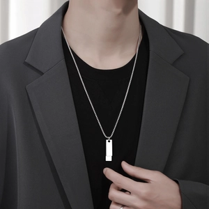 Men's silver rectangular bar pendant necklace in titanium steel on a male model