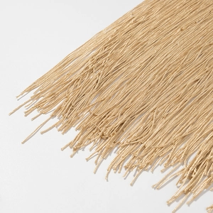 Detailed close-up showing fine texture and metallic shine of golden tassel fringe trim