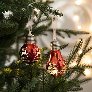 Red Christmas bulb ornament with reindeer design hanging on a tree with bokeh light