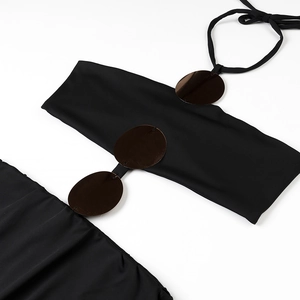 Close-up of black halter swimsuit with brown metallic circular ring details