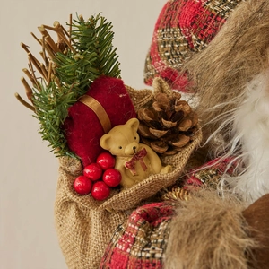 Standing Santa figurine with burlap bag, bear, and pine cones Christmas decoration