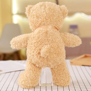Rear view of light brown teddy bear skin with soft curly plush fabric and silk ribbon