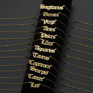 Gothic style 12 zodiac constellation gold necklaces displayed on black velvet cylinder