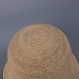 Close-up of the spiral woven texture and natural straw material on top of the bucket hat