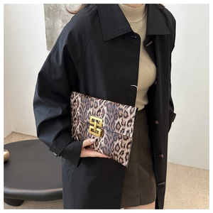 Detail of leopard print envelope clutch with gold geometric metal clasp closure