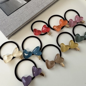 Flat lay of colorful jelly heart hair ties set with ten different vibrant resin colors