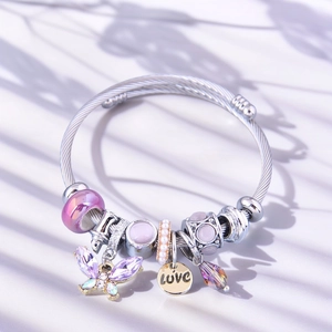 Detail view of silver beaded bracelet with purple butterfly charm and LOVE engraved pendant