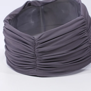 Close-up of dark purple pleated headband showing high-elastic knitted fabric texture