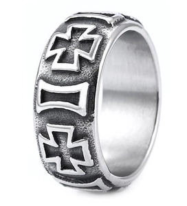 Detail of silver vintage ring with engraved cross and geometric patterns on textured surface