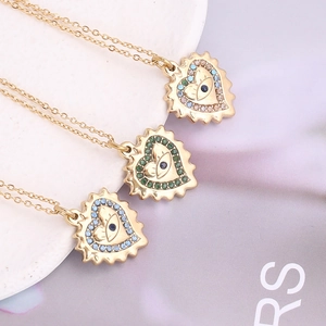 Elegant gold heart pendant necklace set with crystal devil's eye charms for women