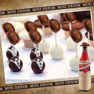 Close-up of mini white cowboy hats decorating party cupcakes and bottle with red bandana