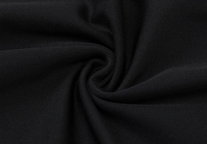 Macro shot of high-quality black knitted fabric texture with elegant spiral fold pattern