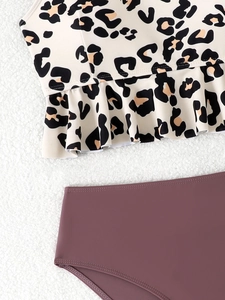 Detail of leopard print bikini top with ruffle hem and high-waist wine red bottom
