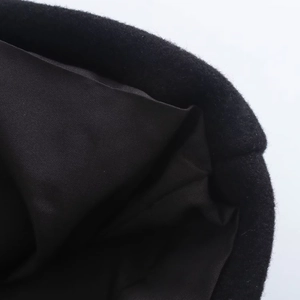 Macro shot of black wool coat lining details showing high quality fabric and stitching