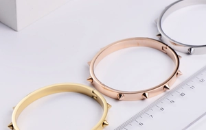 Detailed comparison of gold, rose gold and silver nail stud bangles with size reference