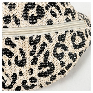 Macro detail of leopard print pattern on straw beach fanny pack with beige zipper