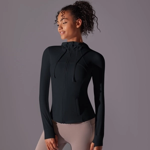 Detail of black slim fit hooded sports jacket showing thumbhole cuffs and zipper design
