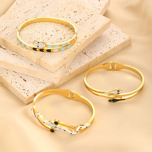 Elegant gold snake bracelets set with sparkling crystals and colorful enamel details