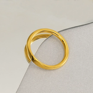 Polished 18k gold plated stainless steel minimalist band ring on reflective surface