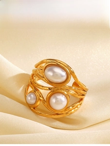 Detailed view of irregular 18K gold plated ring with pearls on elegant satin fabric