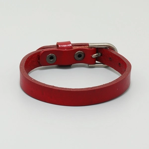Detailed view of red leather bracelet with adjustable metal buckle and belt design