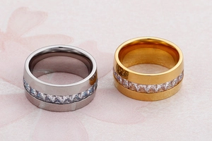 Detail view of silver and gold stainless steel rings with square cubic zirconia inlay