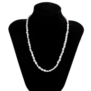 Baroque pearl necklace for men and women displayed on a black velvet mannequin stand