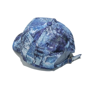 Detail of adjustable metal buckle and blue denim tie-dye pattern on summer baseball cap