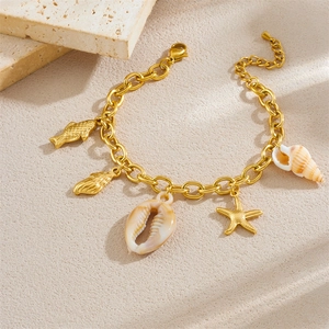 Gold plated ocean bracelet with starfish and seashell charms on natural stone