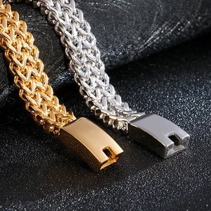 Detailed close-up of woven stainless steel chain with secure rectangular clasp