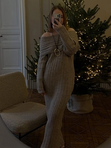 Detail of oatmeal knit off-shoulder dress texture and fit in a cozy holiday setting