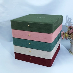 Close-up of luxury velvet jewelry boxes with gold clasps in five elegant Morandi colors