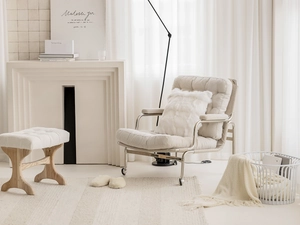 Luxe beige upholstered armchair and ottoman set with a modern sleek metal frame