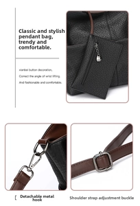 Detail of elephant pattern leather handbag with adjustable strap and small zipper pouch