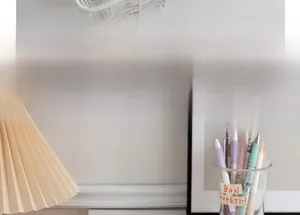 Close-up of colorful gel pens and stationery organizer in a cozy desktop setting