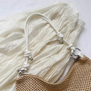 Handwoven beige straw tote bag with white leather knotted straps for summer beach fashion